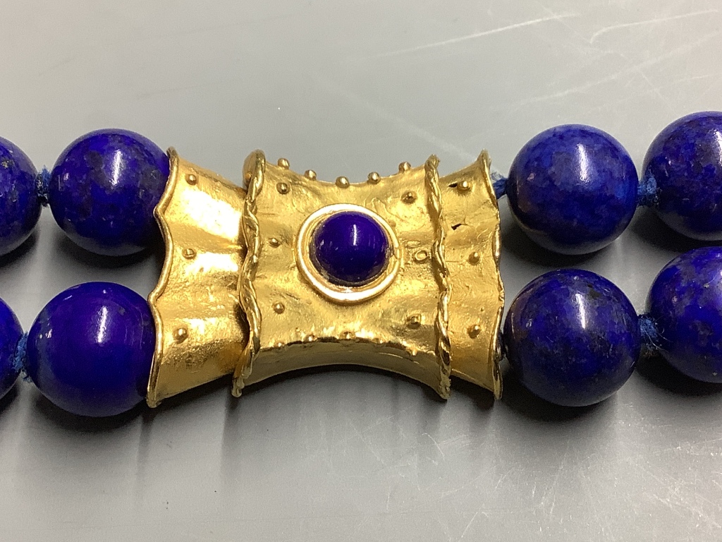A lapis lazuli necklace with fancy gilt metal clasp, 42cm.